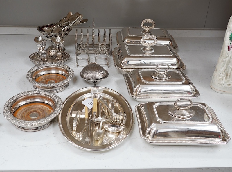A quantity of plated flatware, four entrée dishes, two wine coasters, condiments, three toast racks etc., largest toast rack 16cm wide, 15cm high. Condition - good